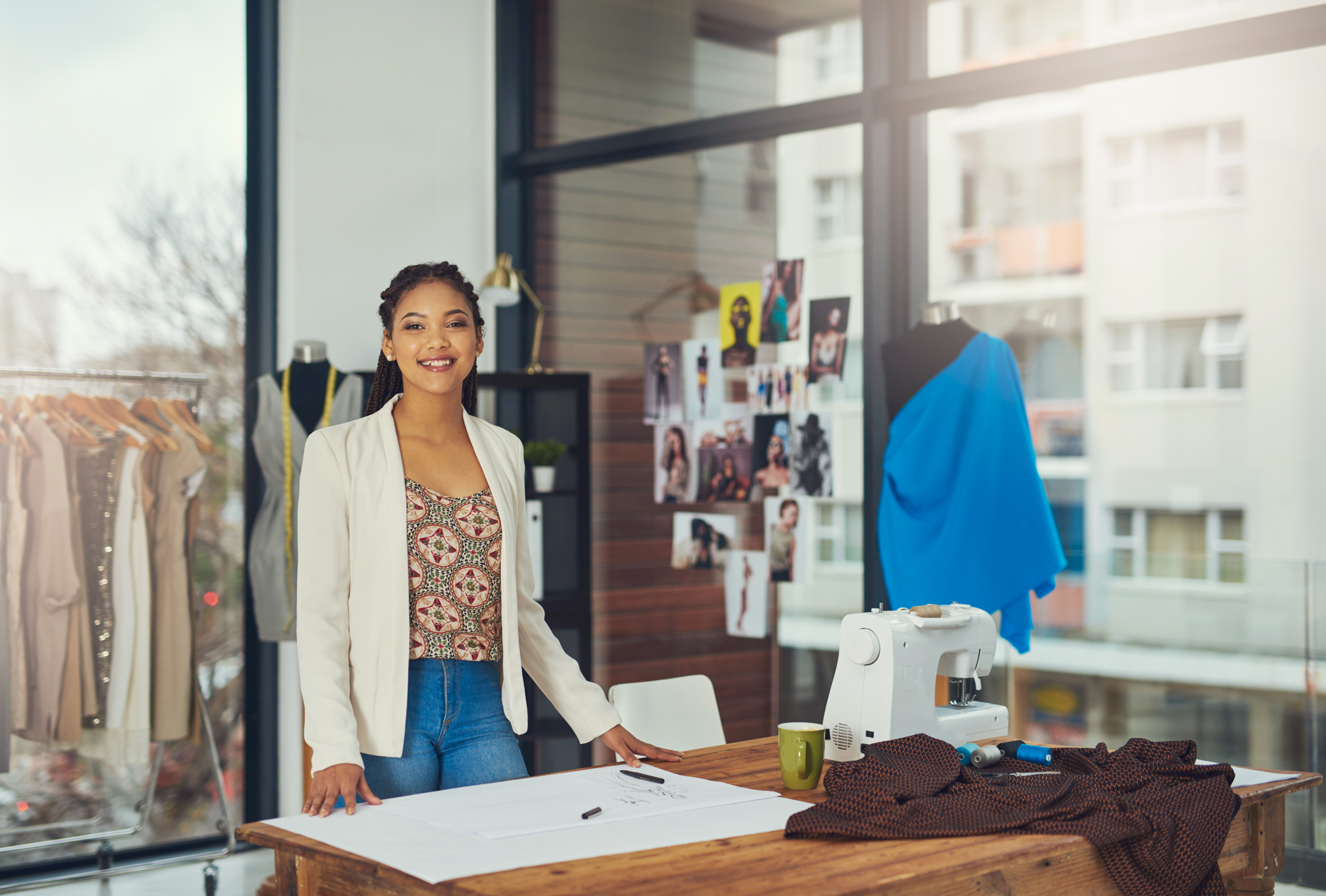 Fashion designer planning work in a clothing studio